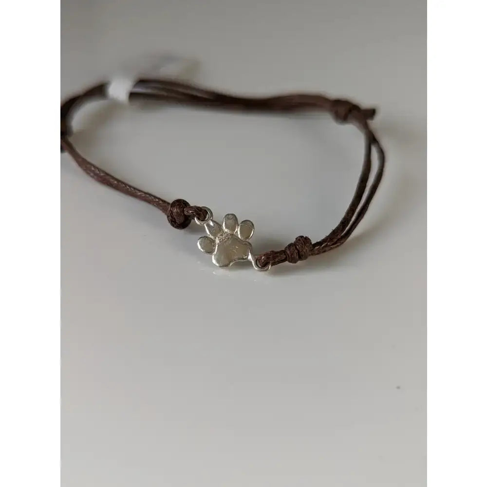 Brown leather cord bracelet with a silver steed paw print charm paw print cord bracelet with steed paw print design
