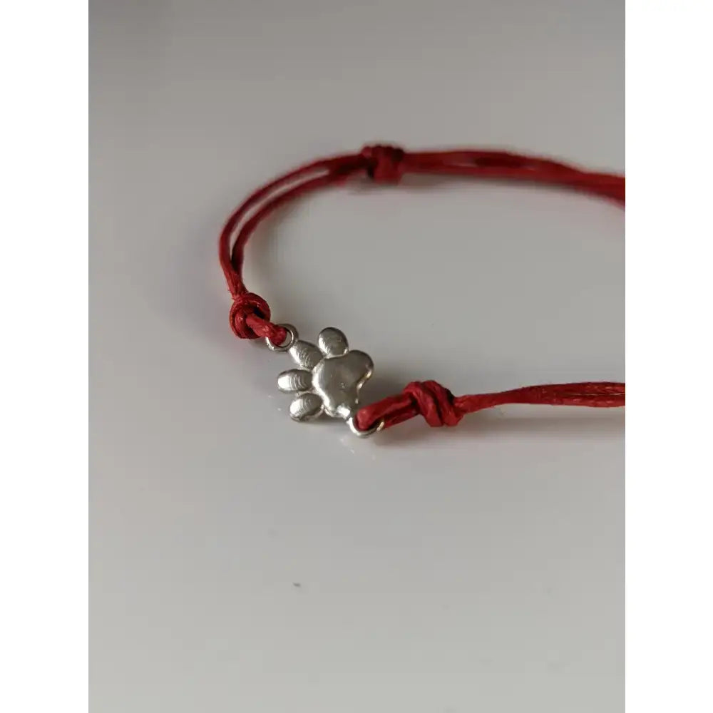 Red cord paw print cord bracelet with silver steed paw print charm perfect for casual wear