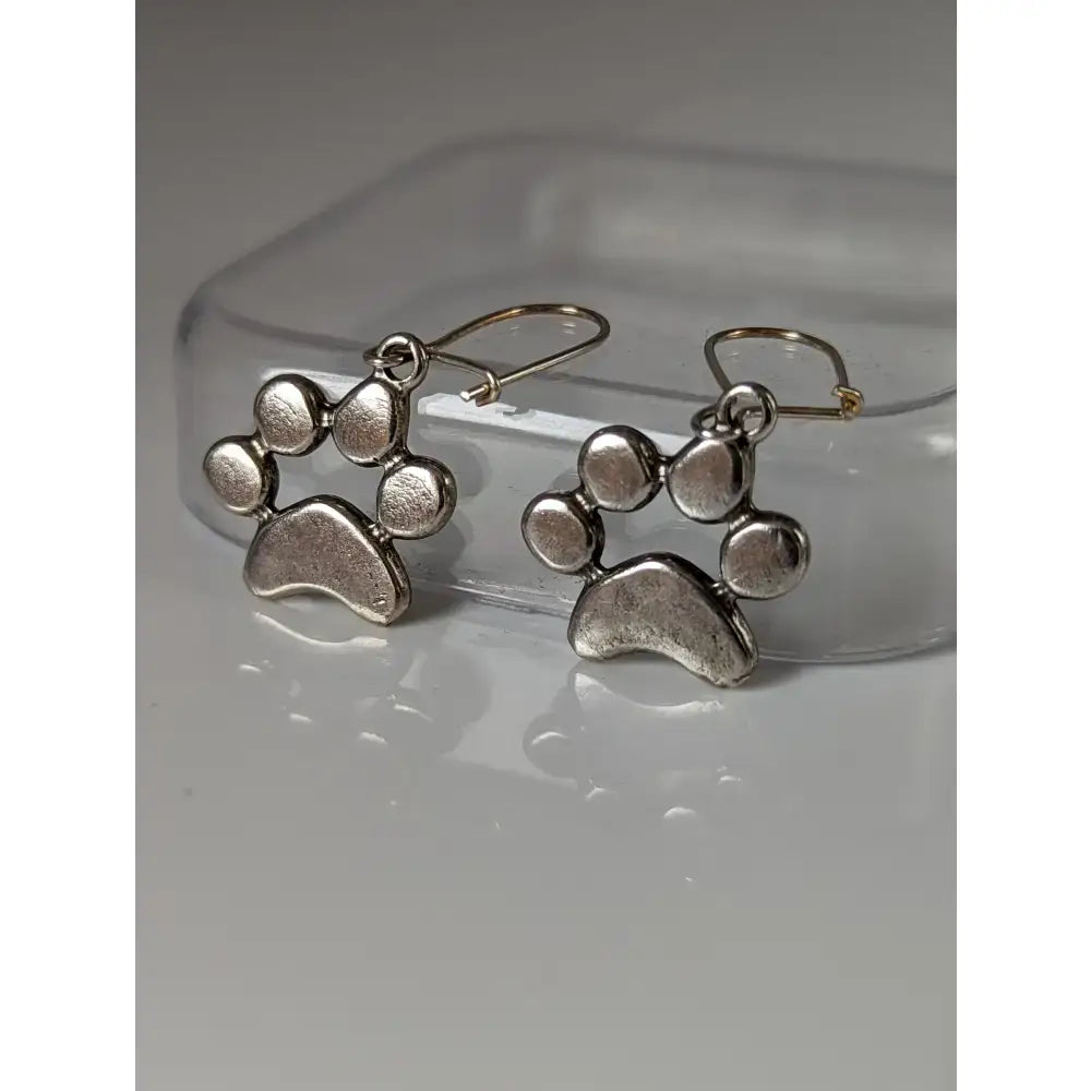Silver steed paw print silver dropped earrings with textured antiqued finish and simple hook closures in silver