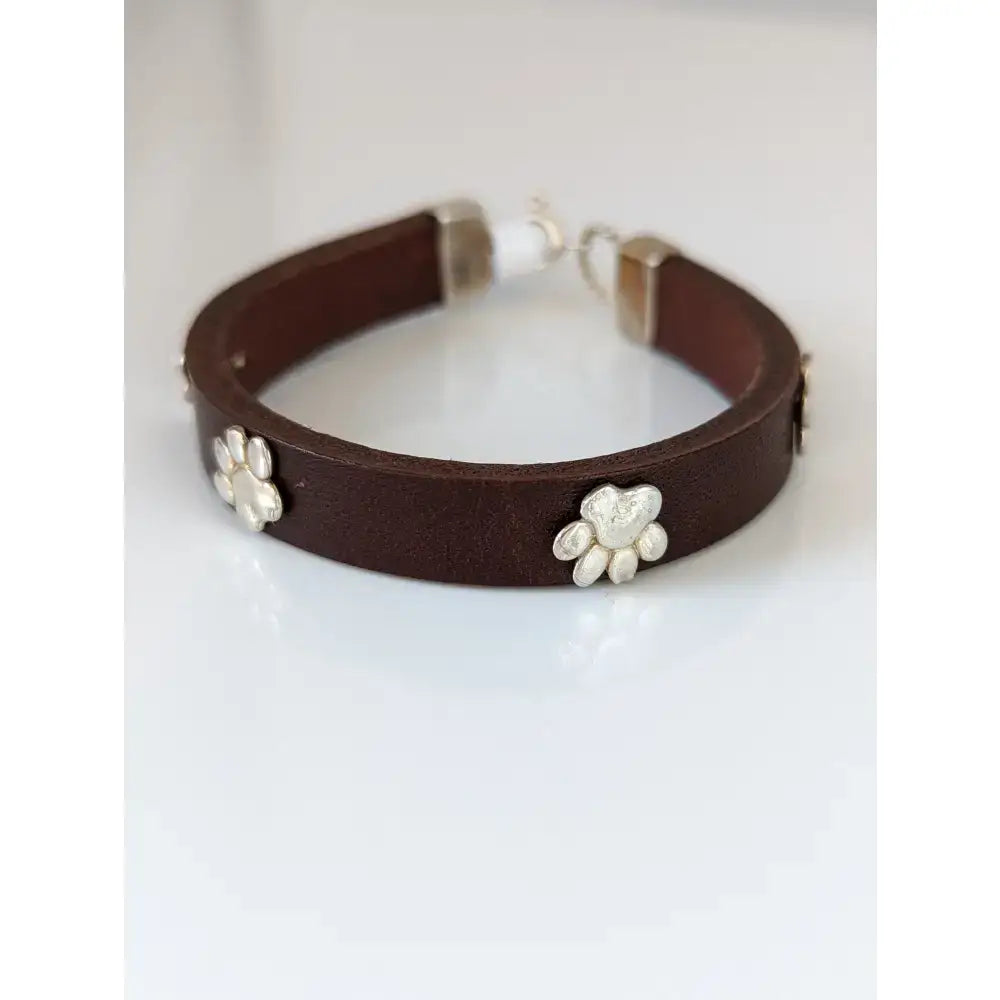 Silver steed leather bracelet with brown leather and silver paw print leather charms and matching metal clasp