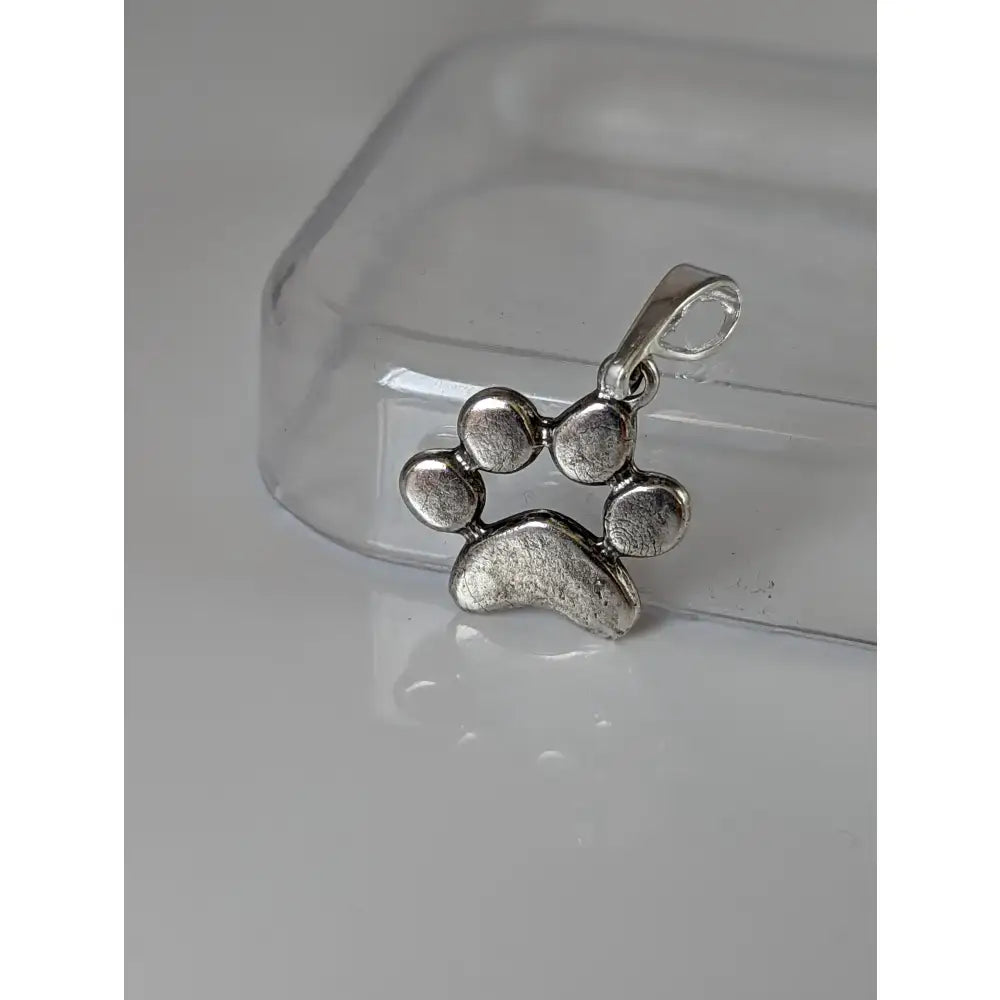 Silver steed paw print silver pendant with a textured rustic finish and small loop for attachment silver pendant
