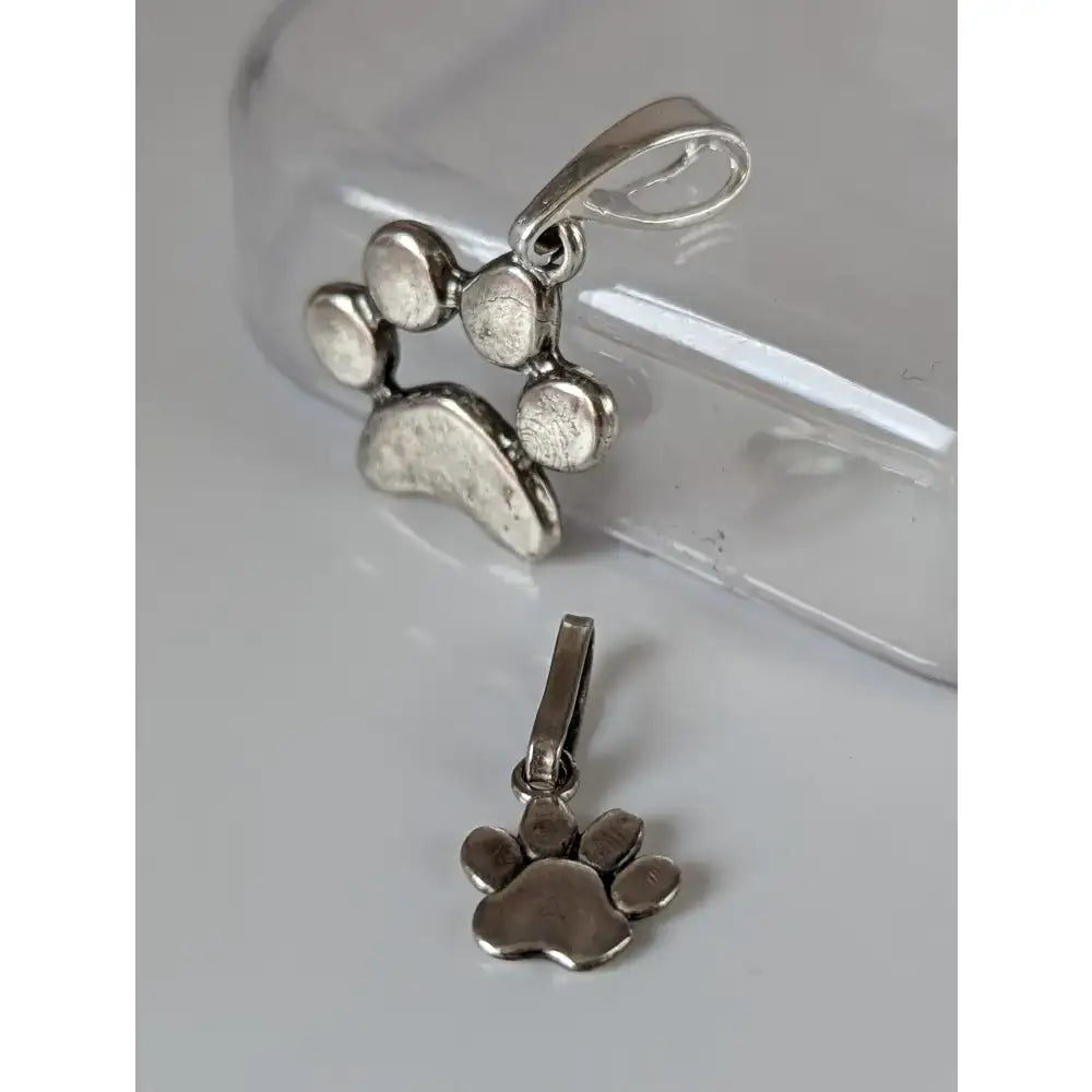 Silver steed paw print silver pendant with textured tarnished finish and polished bail in silver pendant design