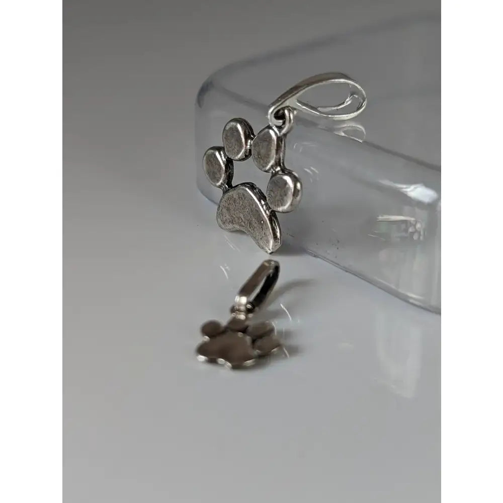 Silver steed paw print silver pendant with textured antiqued finish and small loop for attachment in silver metal