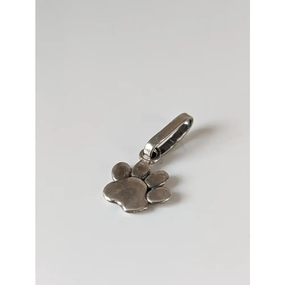 Silver steed paw print silver pendant with polished metallic finish and clasp for easy wear as a silver pendant