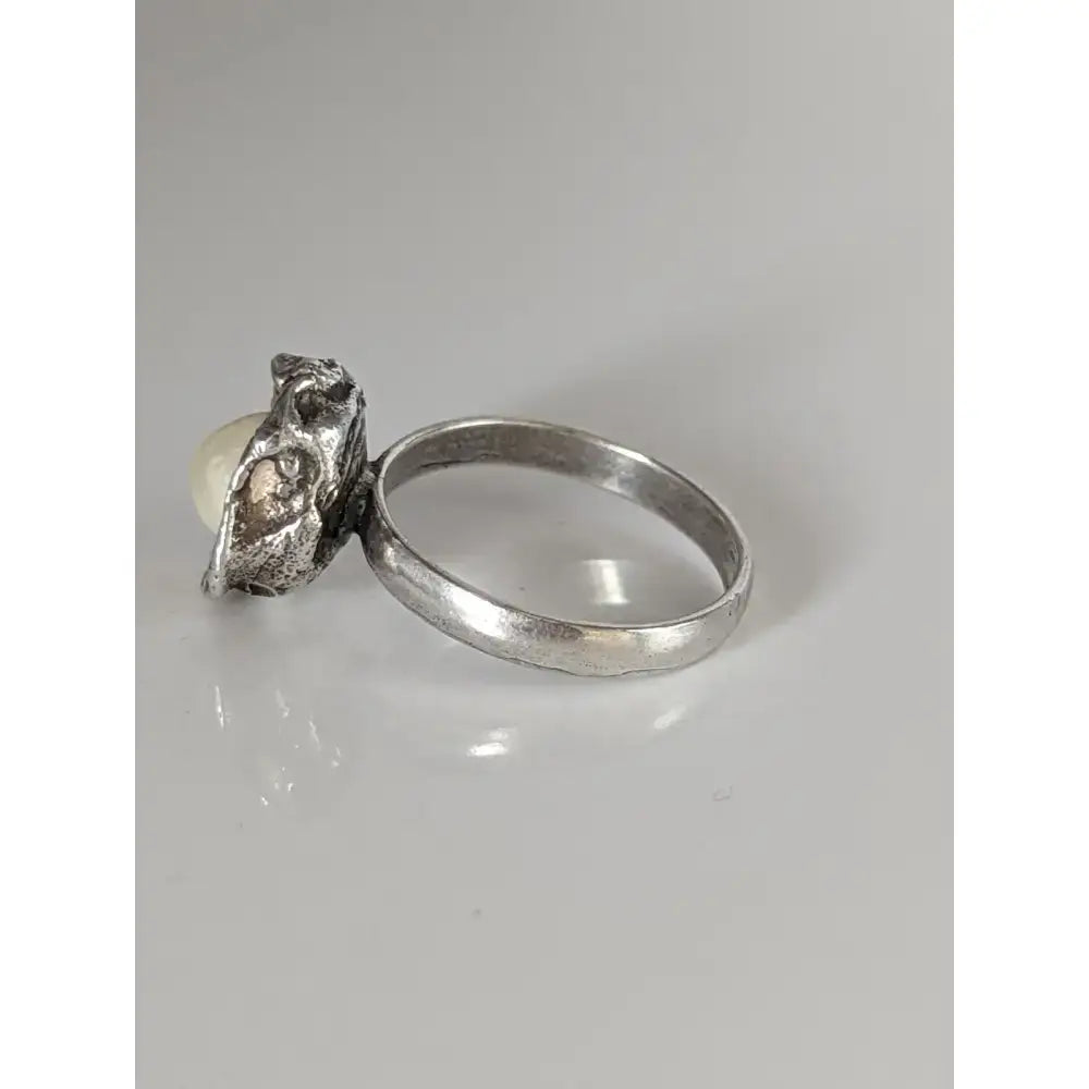 Silver steed pearl flower silver ring featuring a textured silver setting holding an off-white pearl perfect for equestrian jewelry