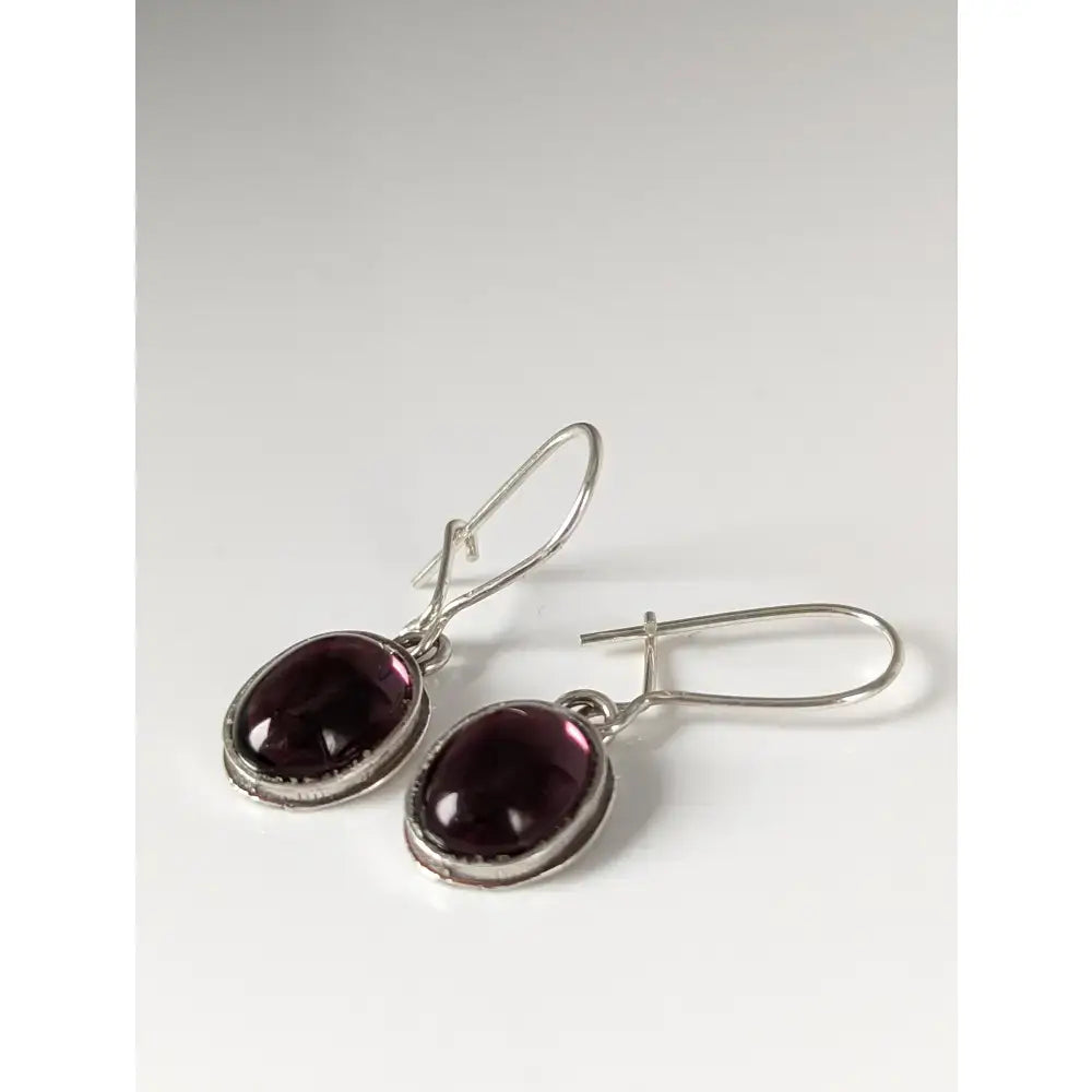 Silver steed purple crystal dropped earrings with oval deep purple gemstones in polished silver dangle style