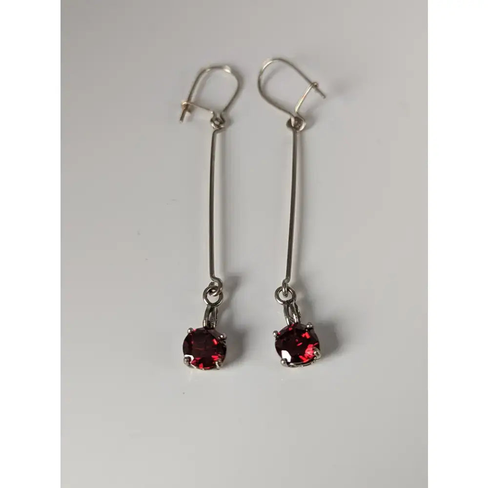 Silver steed red crystal dropped earrings featuring vibrant red gemstones in a simple silver drop design