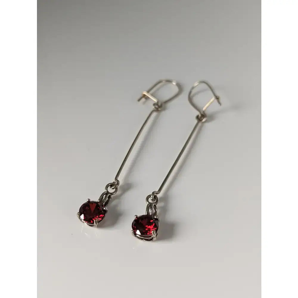 Silver steed red crystal dropped earrings with round faceted red gemstones in sleek silver drop setting