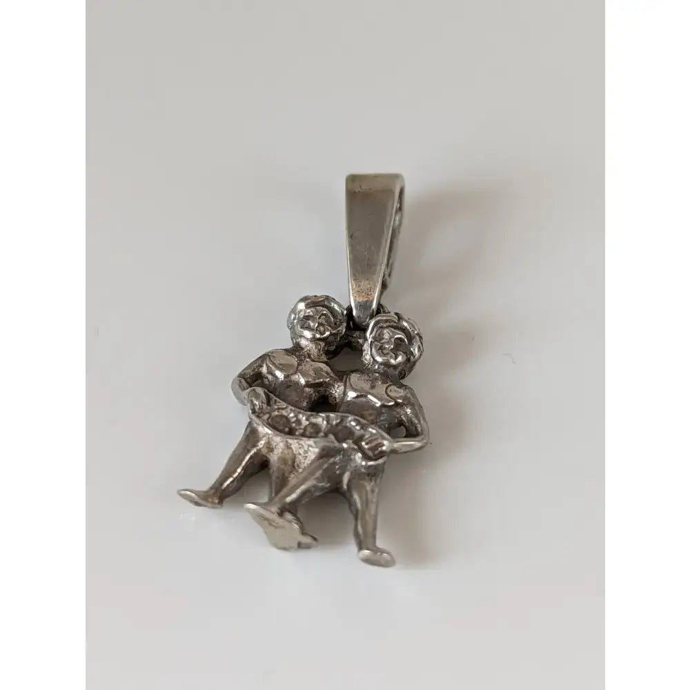 Silver steed romans twins silver pendant featuring a silver pendant with two detailed embracing figures in a dynamic pose
