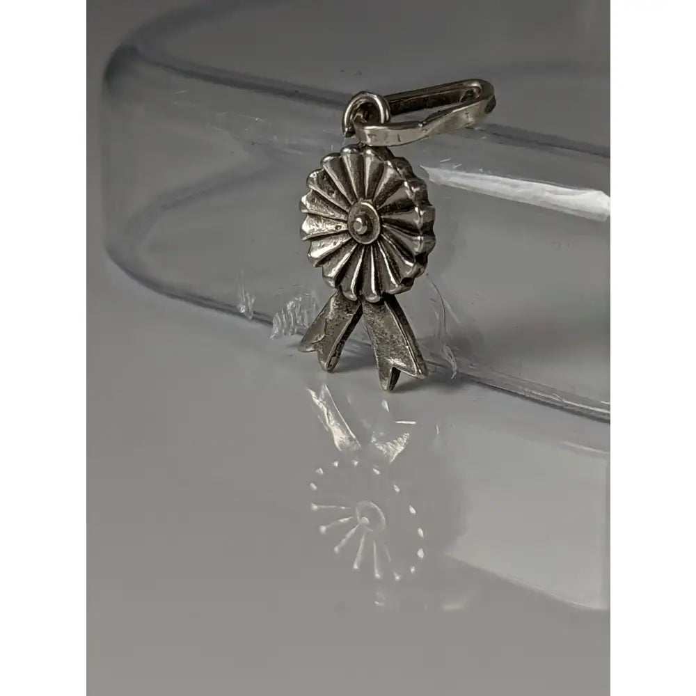 Silver steed rosette sterling silver pendant with detailed petal and bow design as a metallic ribbon award charm
