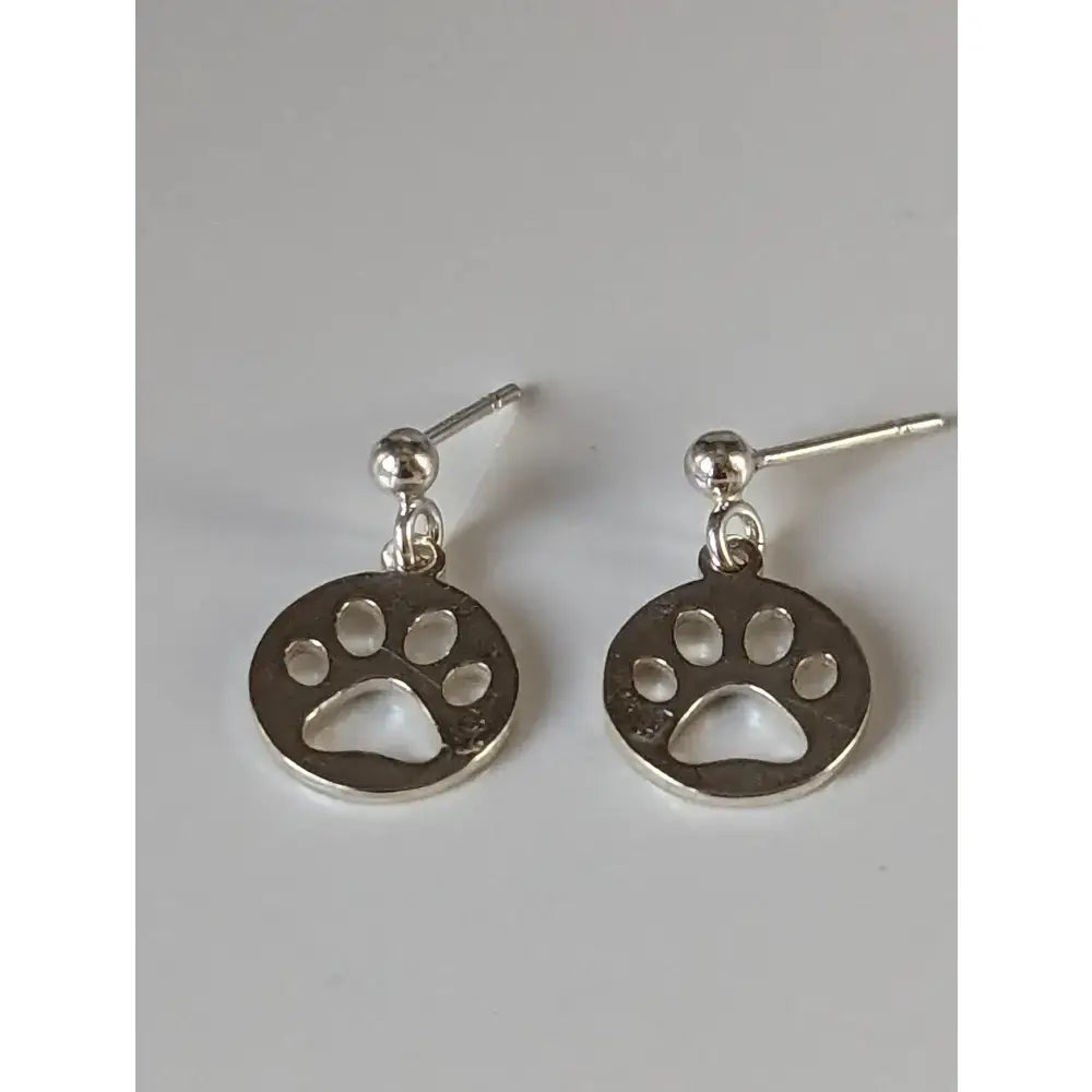 Silver steed round stud earrings featuring silver paw print tag with polished finish and small ball accents