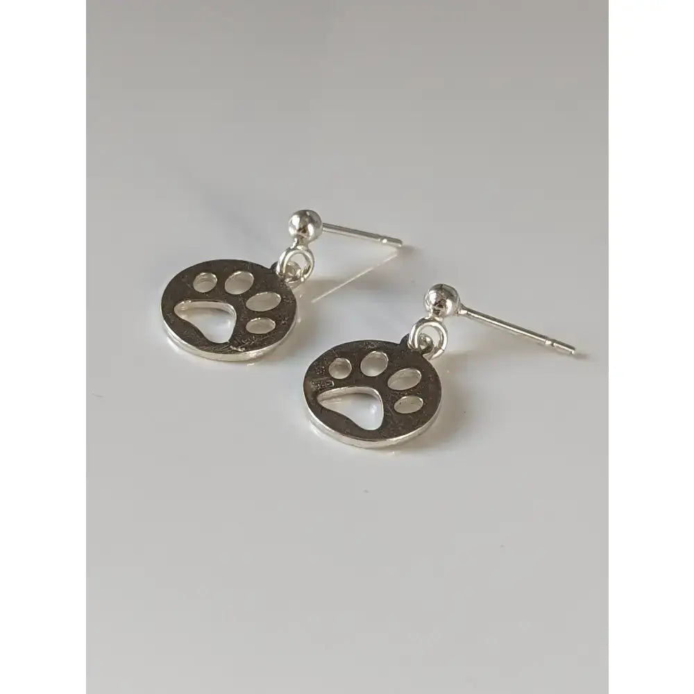 Silver steed round silver stud earrings with polished metallic paw print tag and simple stud design