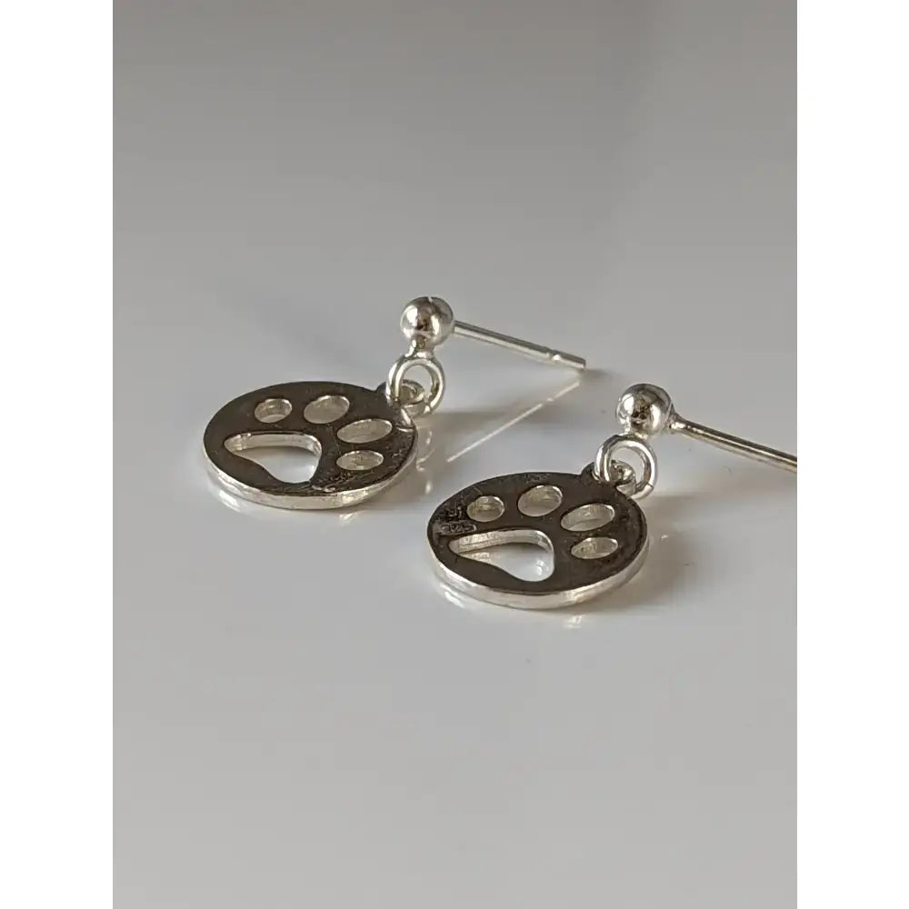 Silver steed round silver stud earrings with polished paw print tag dangle and simple stud backs