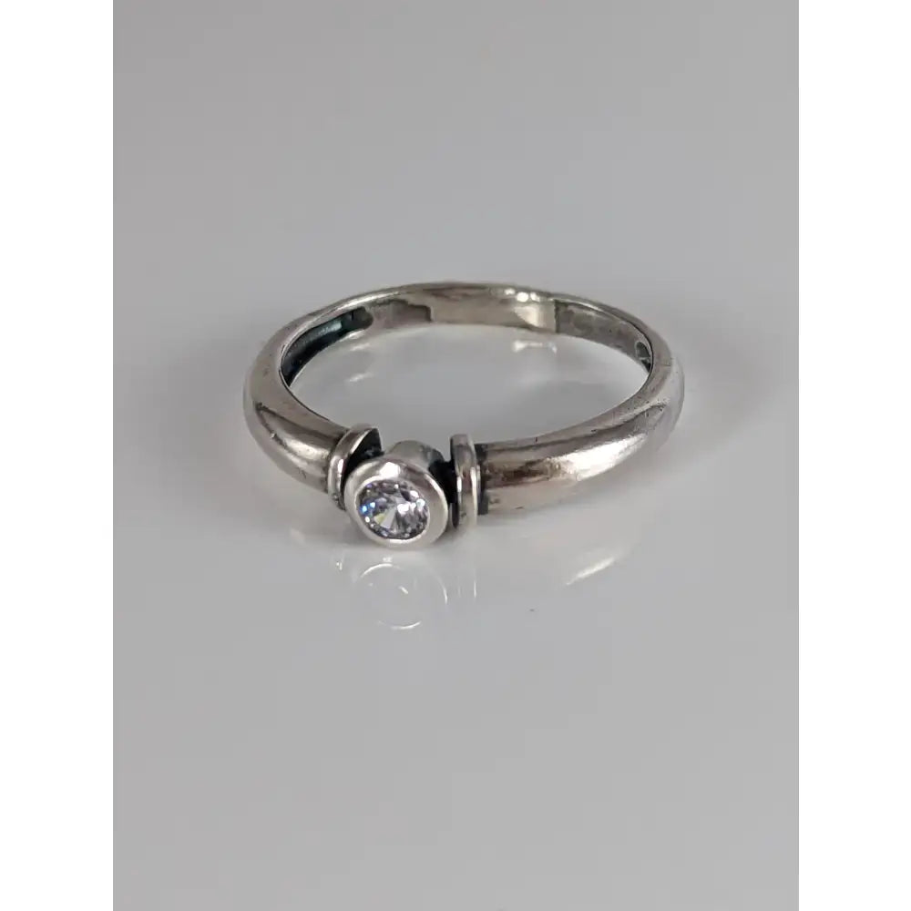 A sleek silver steed silver round zirconia ring with a single clear round-cut gemstone in a modern design