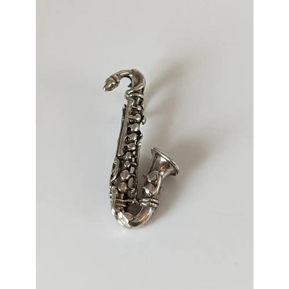Silver steed saxophone silver pendant featuring a polished silver pendant shaped like a detailed saxophone