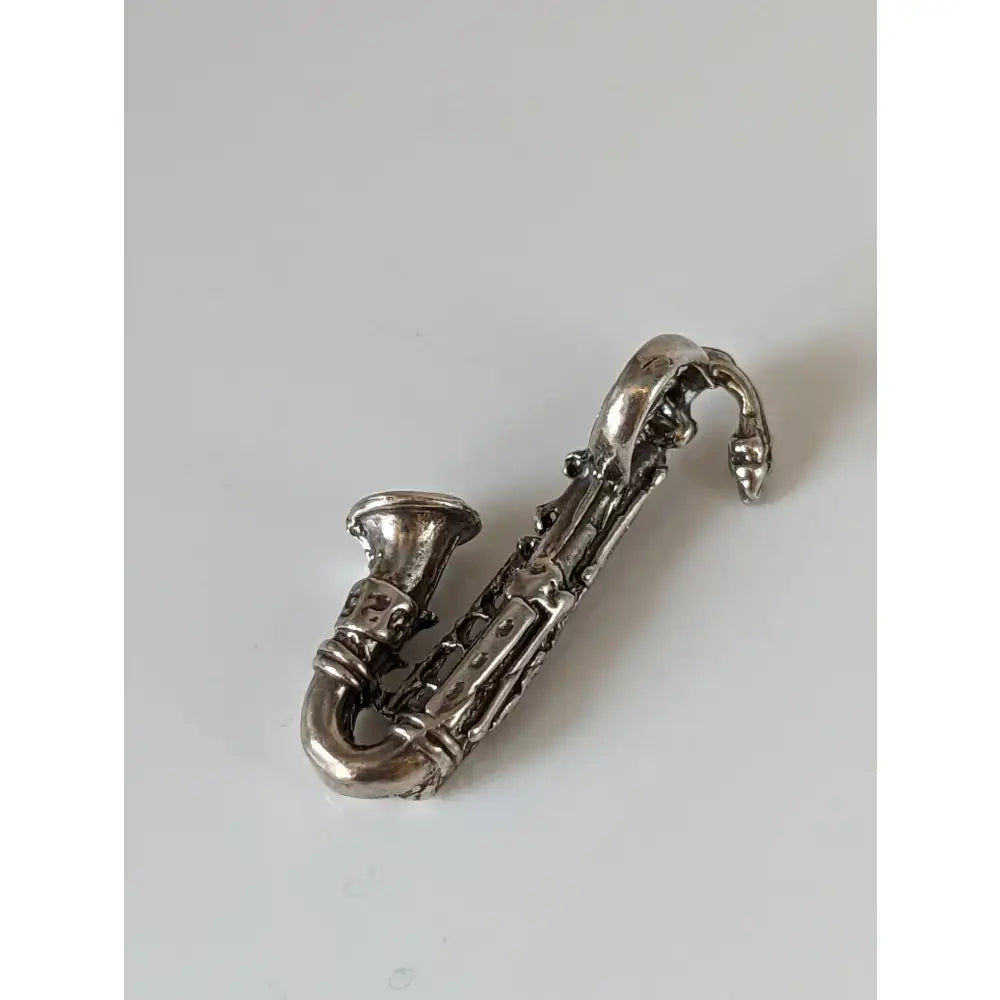 Silver steed saxophone silver pendant shaped like a silver pendant with intricate detailing and polished finish