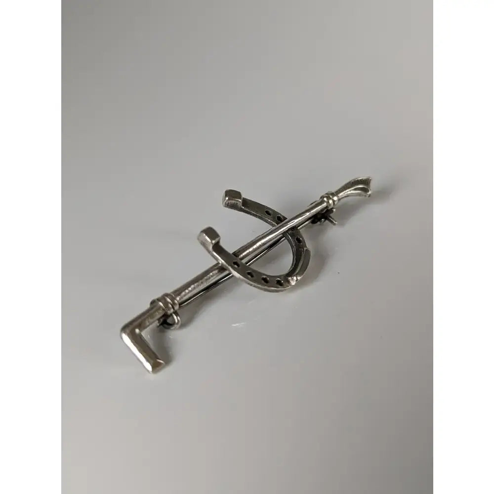 Silver steed shoe and cane silver brooch shaped like a horseshoe and key stock tie pin in silver metal