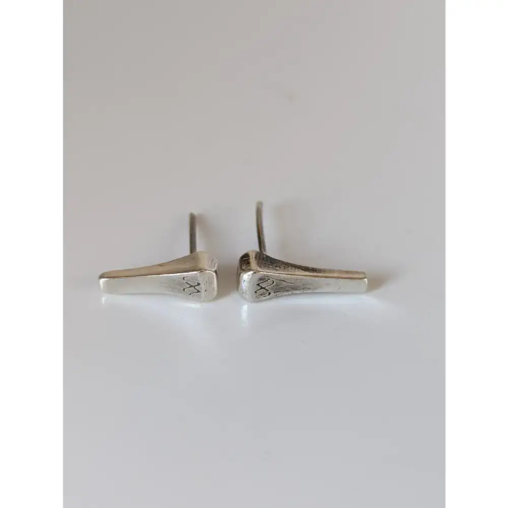 Silver steed short hoof nail stud earrings in silver with matte finish and subtle engraved details