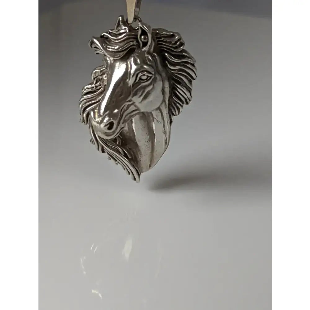 Silver steed signature horse head pendant in polished silver metal with detailed mane and expressive eyes