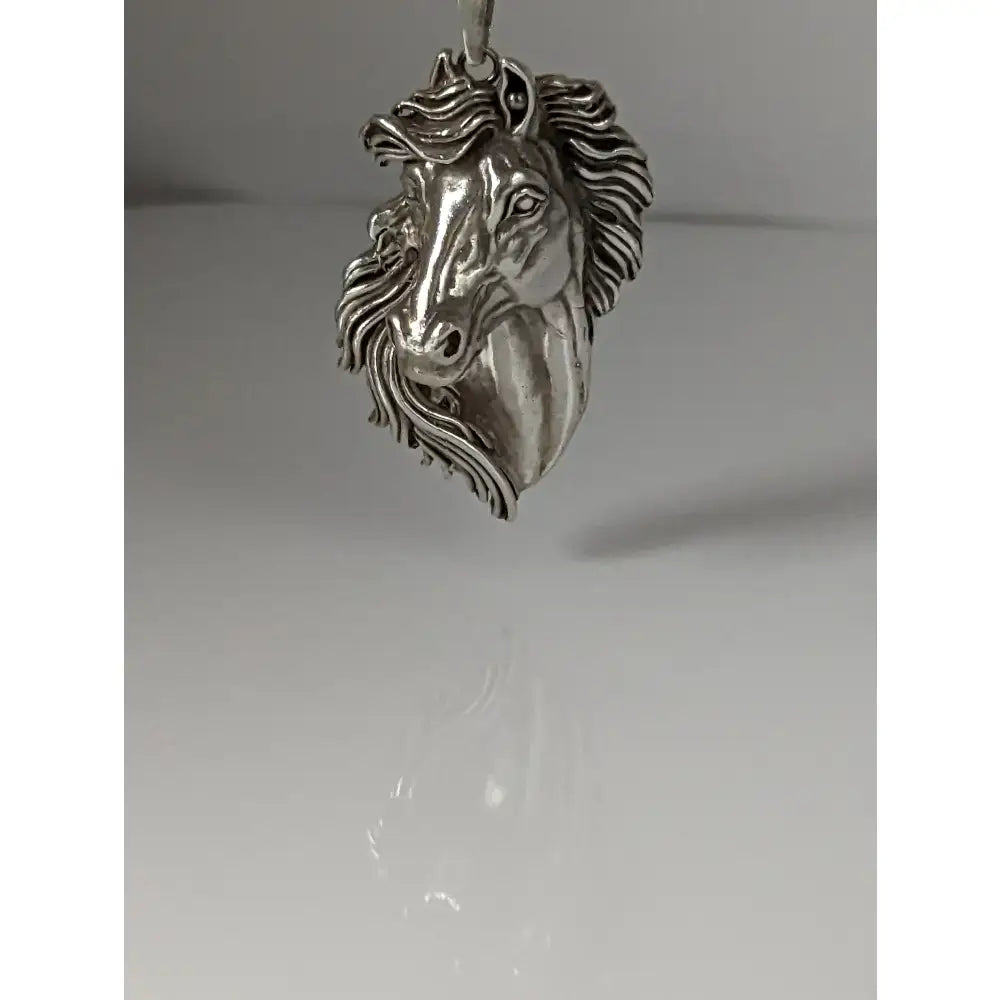 Silver steed signature horse head pendant in silver with detailed mane crafted from metallic material