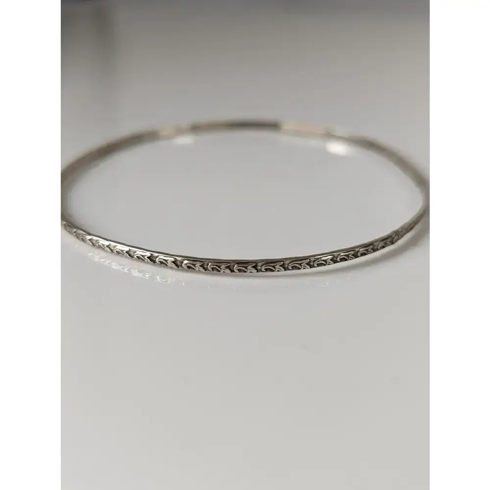 Silver steed slim silver bangle with intricate floral engraving on a vine silver bangle design in silver tone