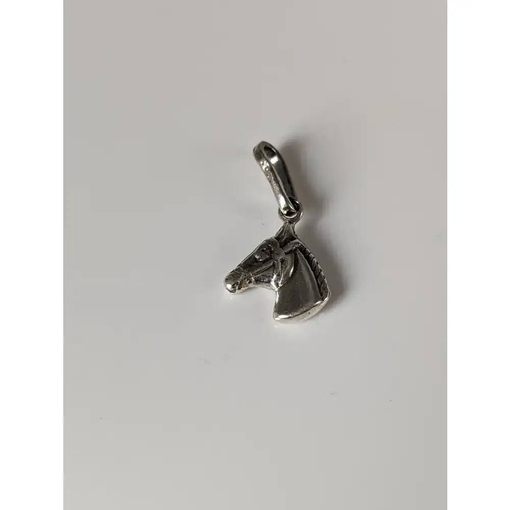 Silver steed small silver pendant featuring a small horse head charm with detailed features and polished finish