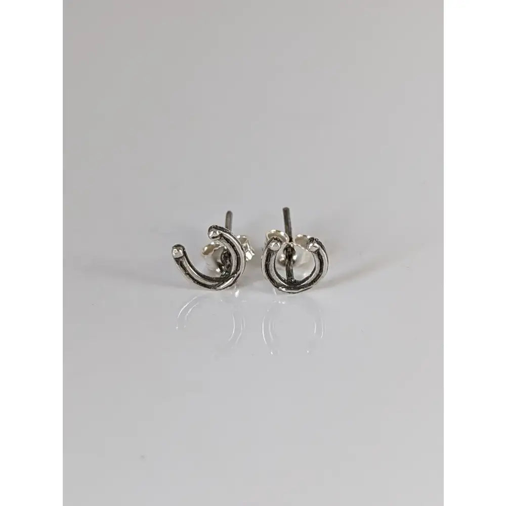 Silver steed small sterling silver horseshoe stud earrings with a minimalist textured design