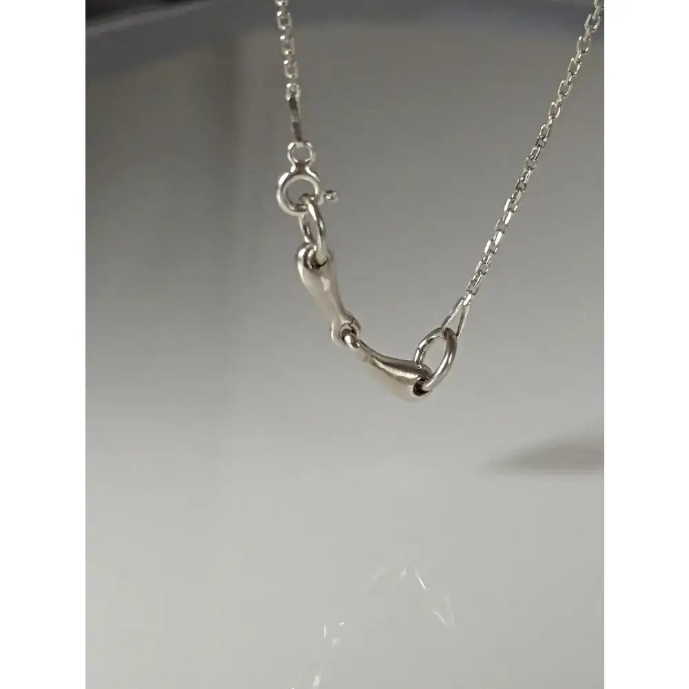 Silver steed snaffle necklace featuring a silver horsebit pendant with a delicate chain and polished metal finish