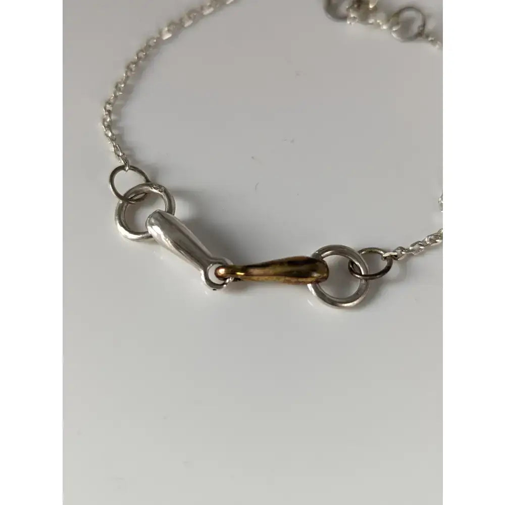 Silver steed snaffle chain delicate bracelet with silver and gold-toned horsebit style and polished finish