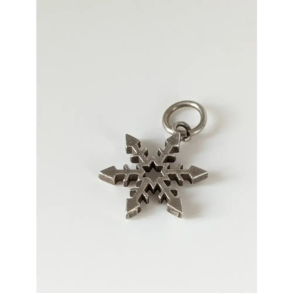 Silver steed snowflake sterling silver pendant with intricate symmetrical design and small ring for attachment