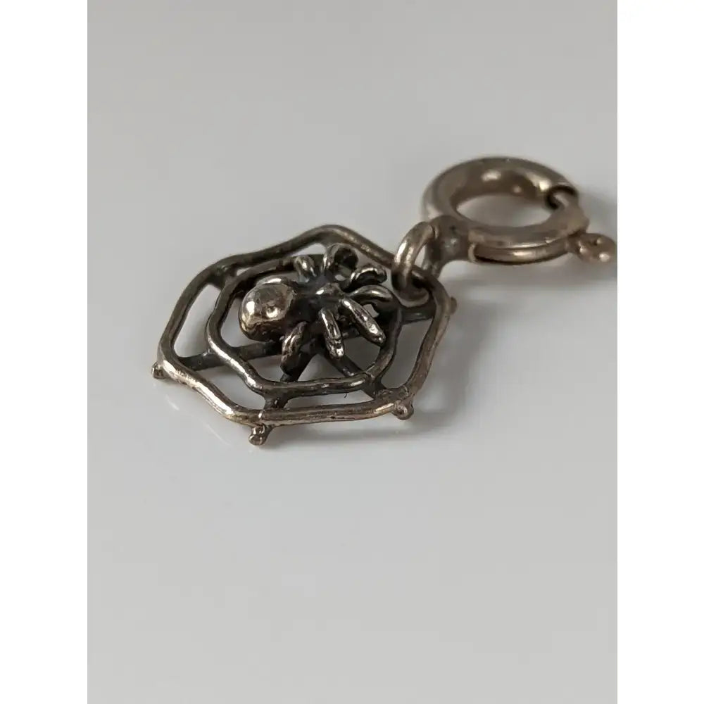 Silver steed spider web silver charm featuring intricate silver spider web design and secure clasp for equestrian jewelry