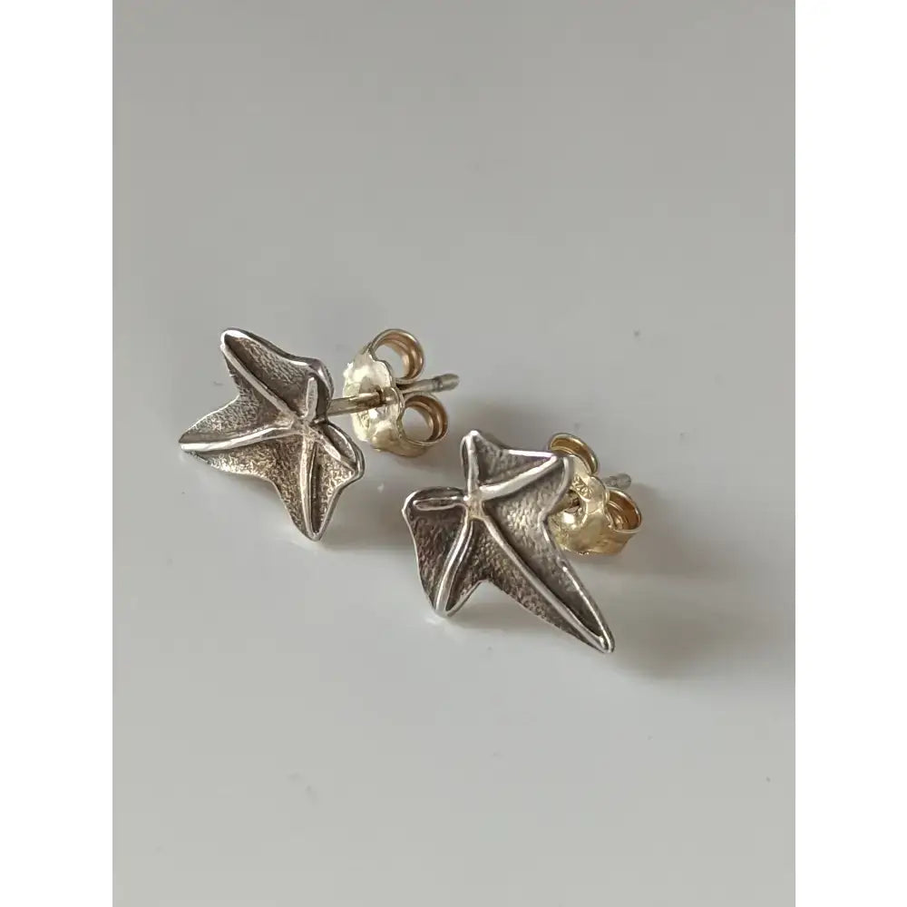 Silver steed sweetgum leaf stud earrings with textured sterling silver stars and gold-toned backings