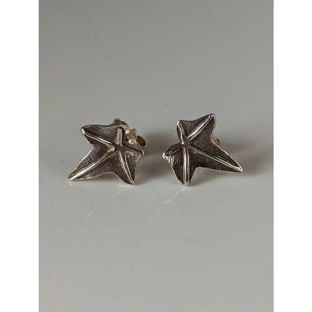 Silver steed sterling silver sweetgum leaf stud earrings with a textured handcrafted finish in star shape