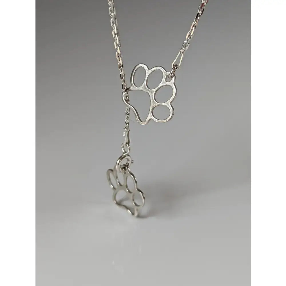 Silver steed thread through double paw print silver necklace with delicate chain and two dangling openwork paw charms