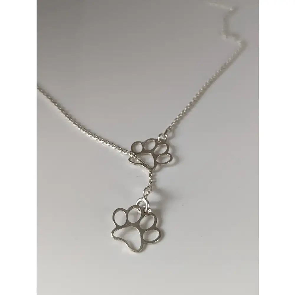Silver steed thread silver necklace with a delicate chain and double paw print pendant in silver