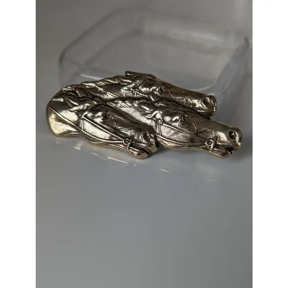 Silver-toned metal stock tie pin featuring the silver steed three racing thoroughbreds horse heads in a row