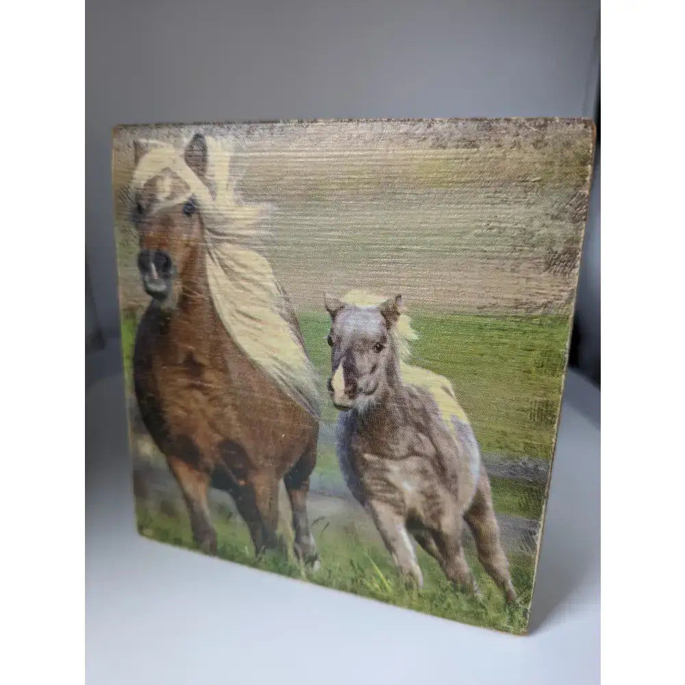 Rustic wooden silver steed tissue box with painted brown and gray horses with flowing manes on canvas surface