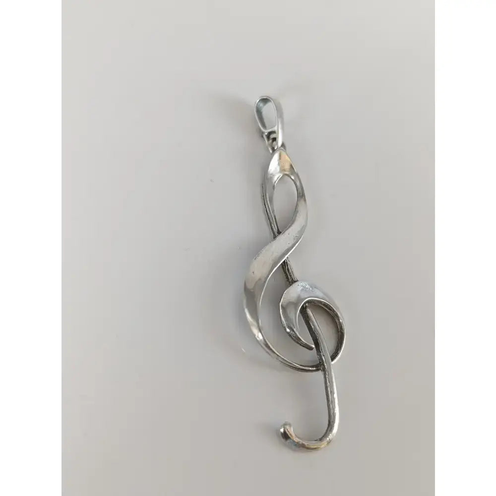 Silver steed treble elegant silver pendant with polished reflective finish and flowing treble clef silver design