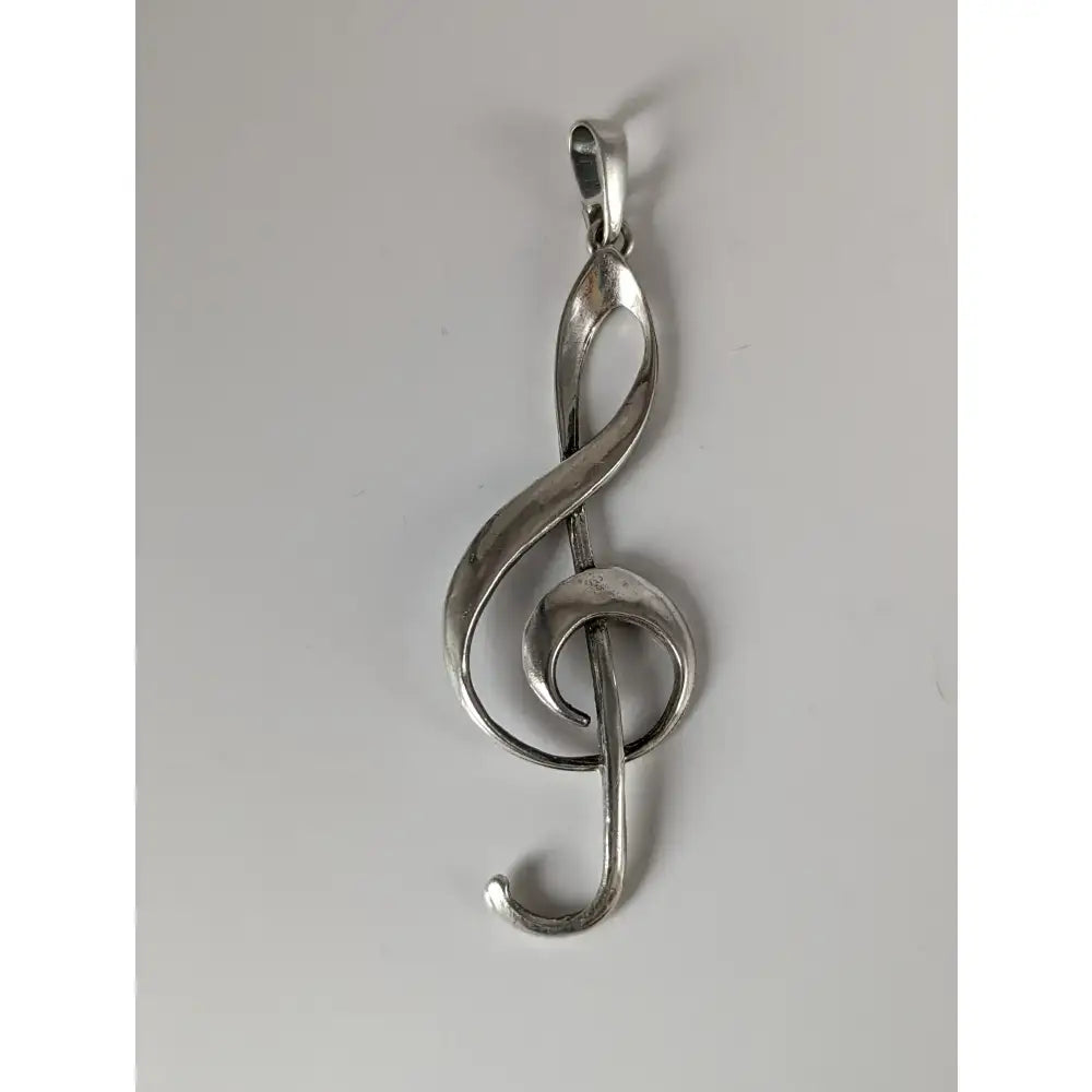 Silver steed treble clef silver pendant with a sleek polished metallic finish and elegant flowing design