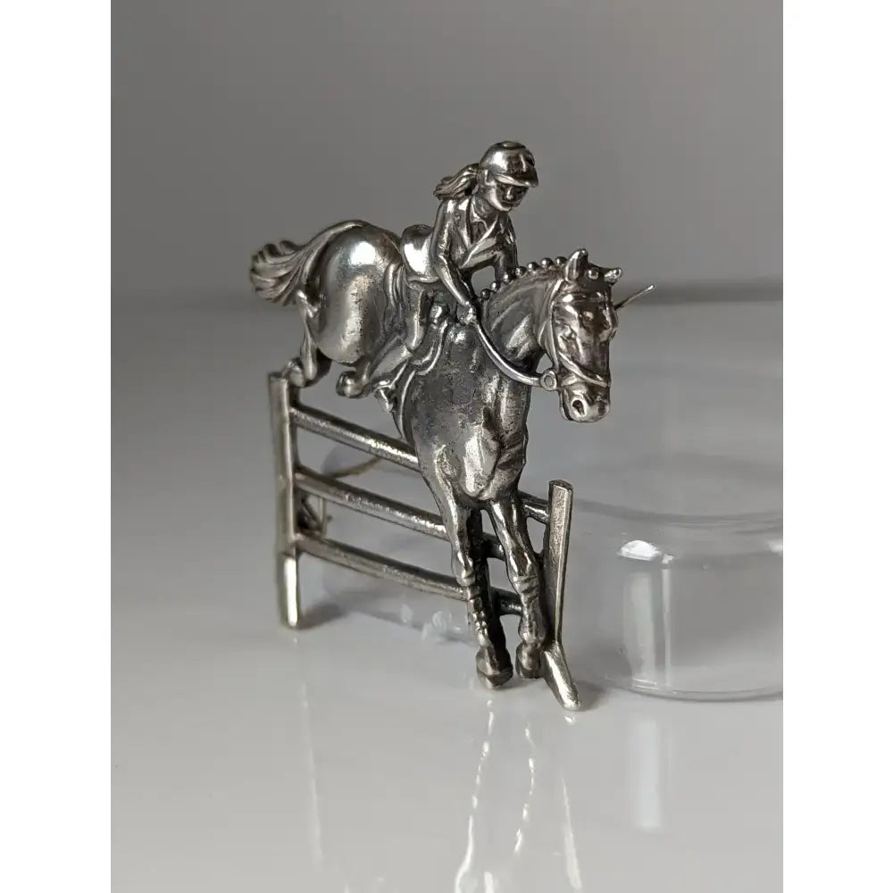 Silver steed triple bar jump silver-colored metal jumping brooch and stock tie pin with rider on horse mid-jump