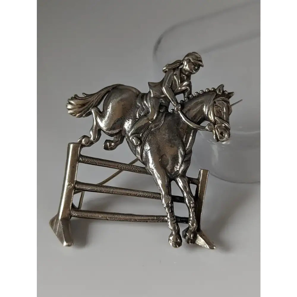 Silver steed triple bar jump silver jumping brooch showing rider and horse mid-jump for stock tie pin use