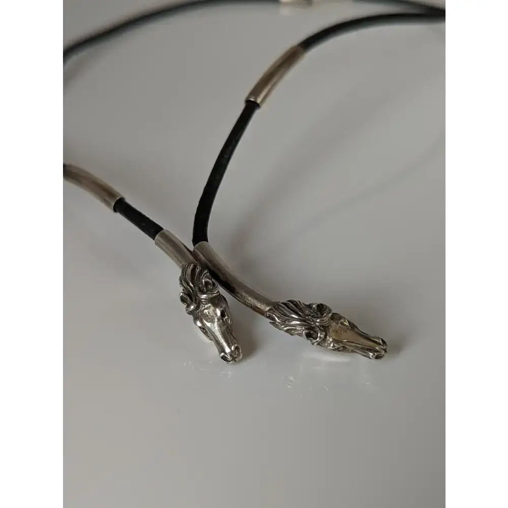 Silver steed two horse heads pendant necklace with silver horse head design and black leather cord necklace with metallic accents