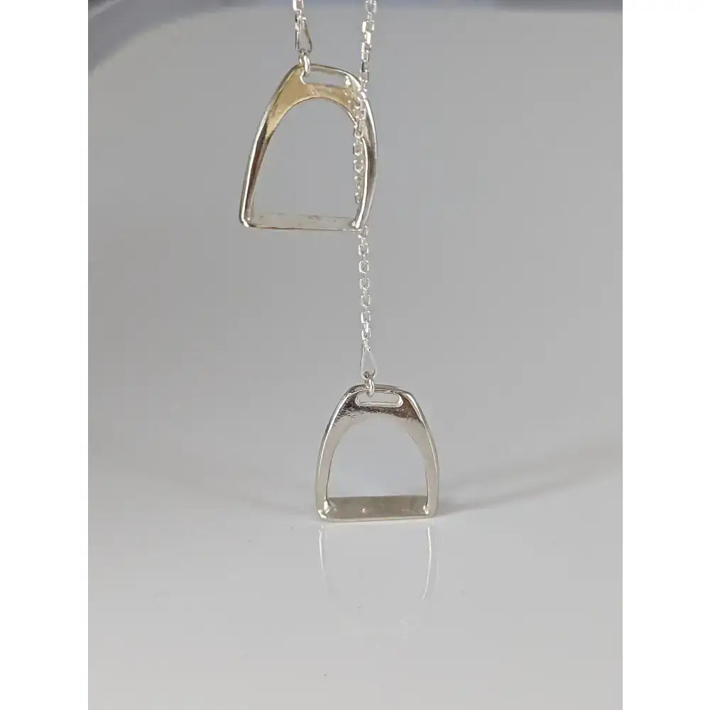 Silver steed equestrian jewelry featuring a polished silver two stirrups necklace with sleek minimalist design