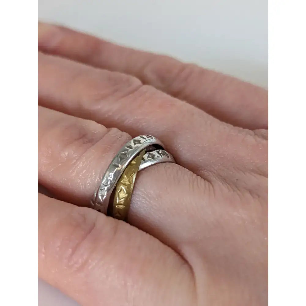 Silver steed two tone two interlocking bands featuring silver diamond cut and gold embossed designs