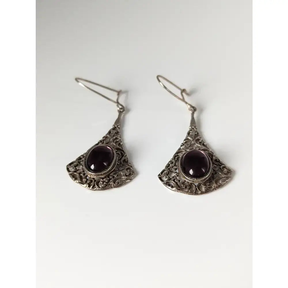 Silver steed vintage filigree purple dropped earrings with oval dark purple gemstones in an ornate fan-shaped design