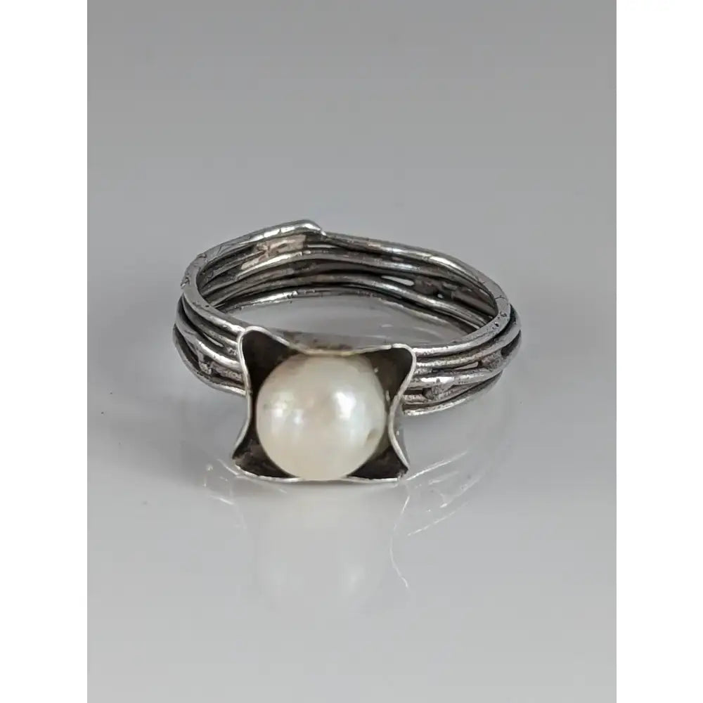 Silver steed wired ring featuring a textured multi strand sterling silver band with a white pearl in a square bezel