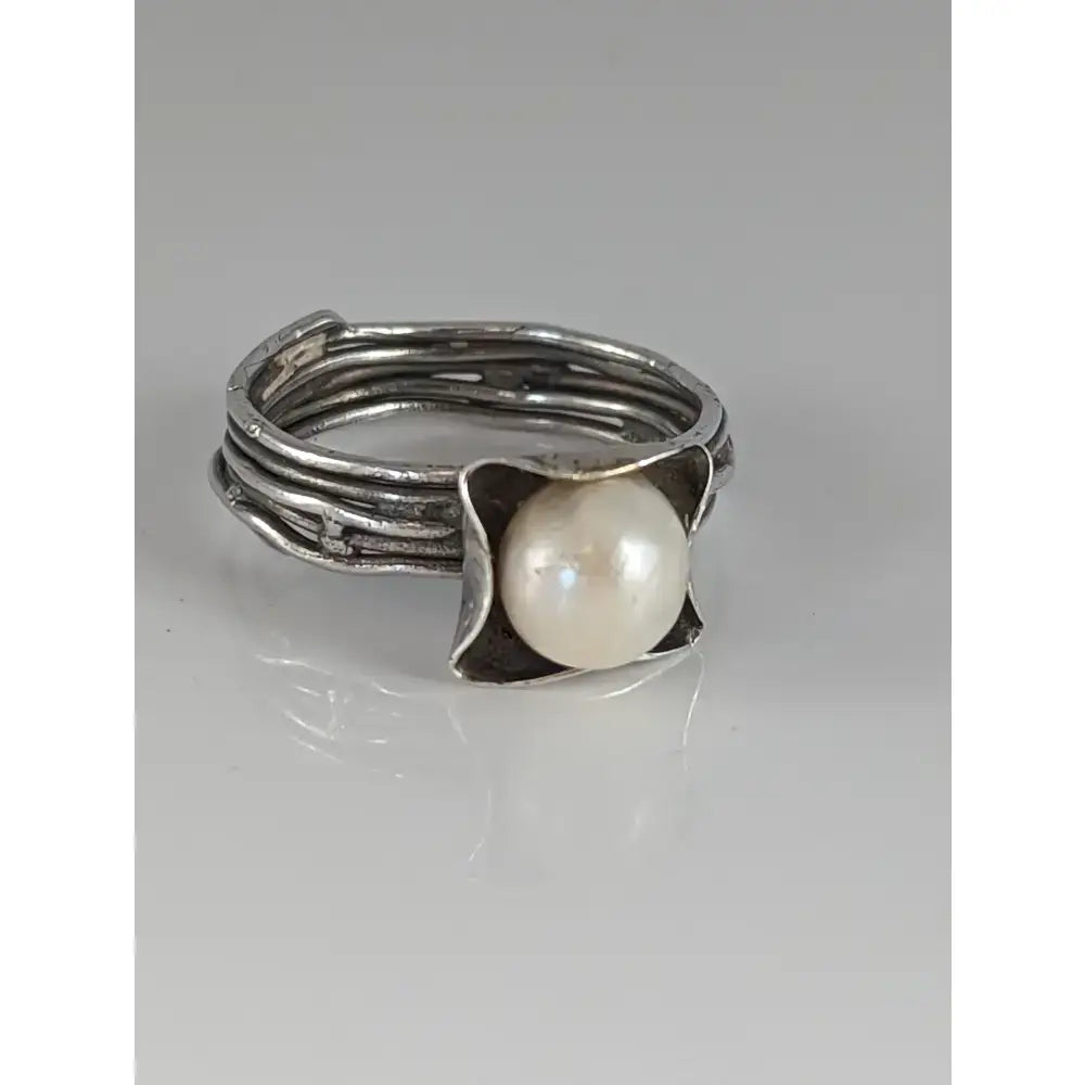 Silver steed wired ring with pearl featuring a textured layered silver band and organic leaf-like sterling silver frame