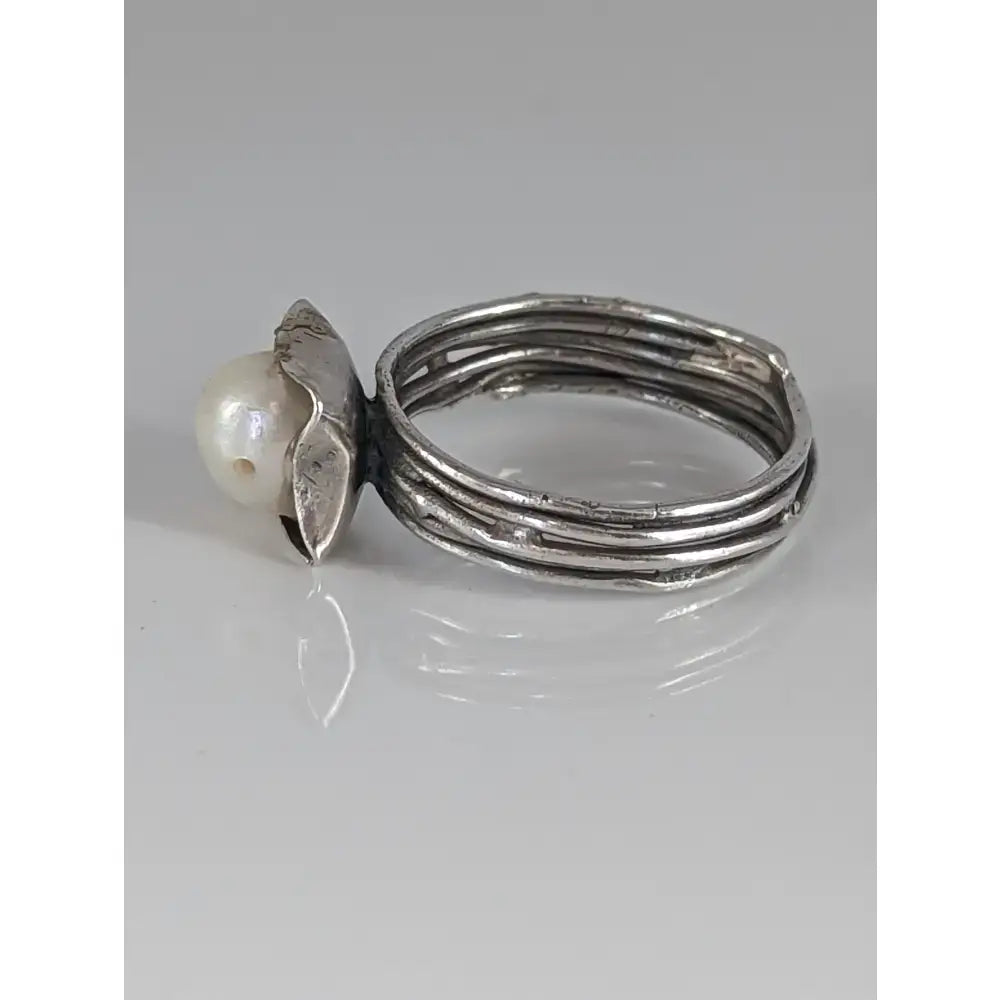 Silver steed wired ring with a textured layered sterling silver band and a leaf setting holding a single pearl