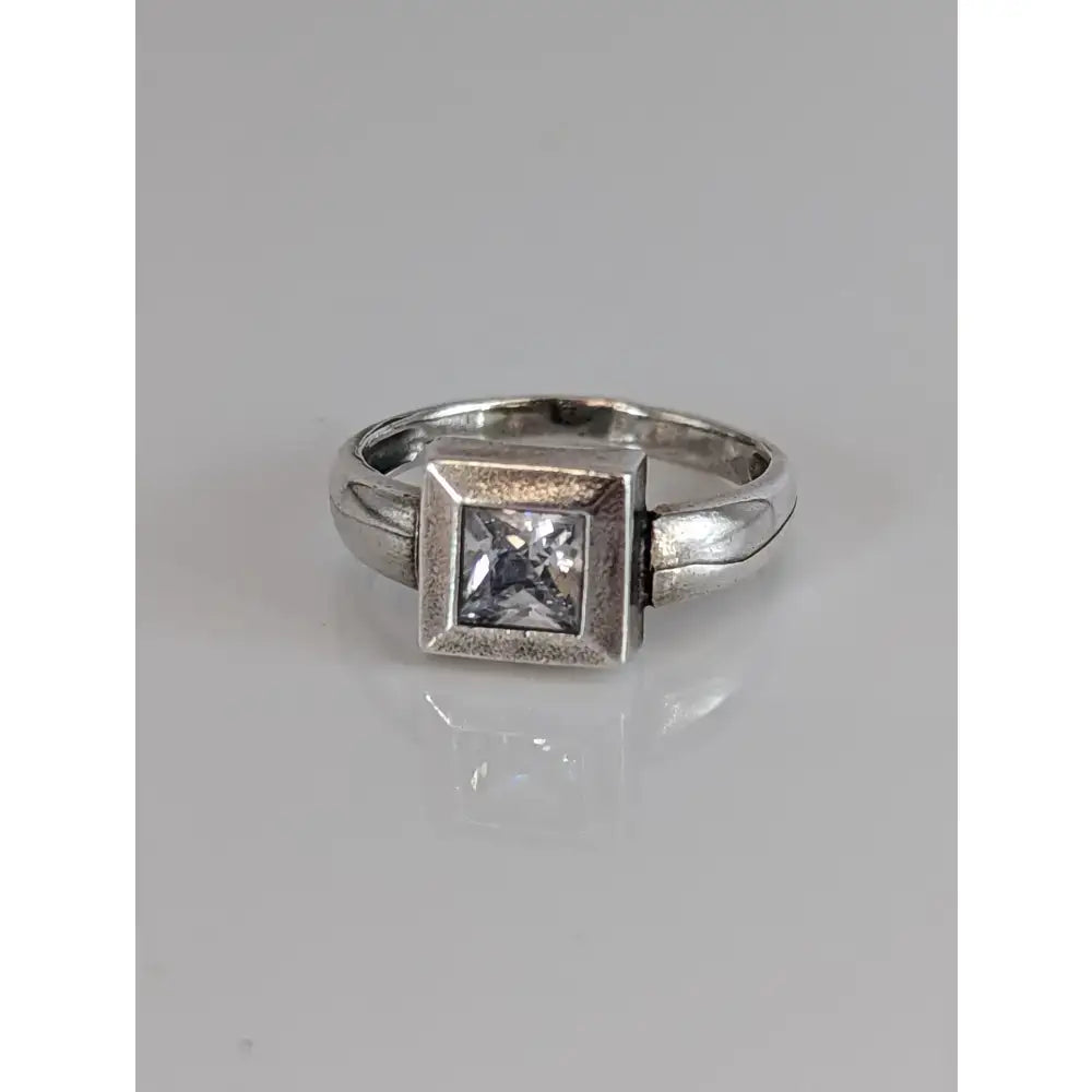 Silver steed zirconia square ring features a clear zirconia square gemstone set in a textured silver band