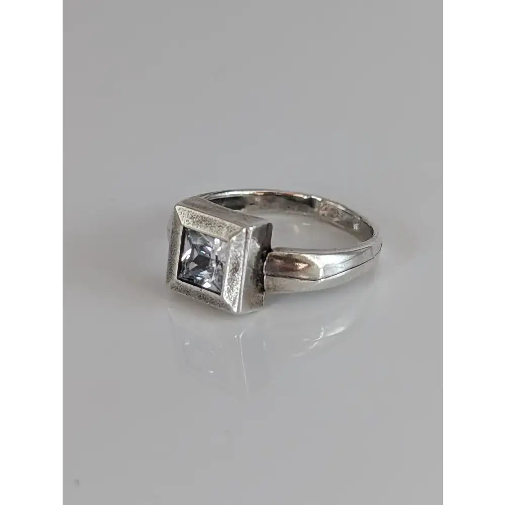 Silver steed zirconia square ring with clear square-cut gemstone set in textured geometric silver band
